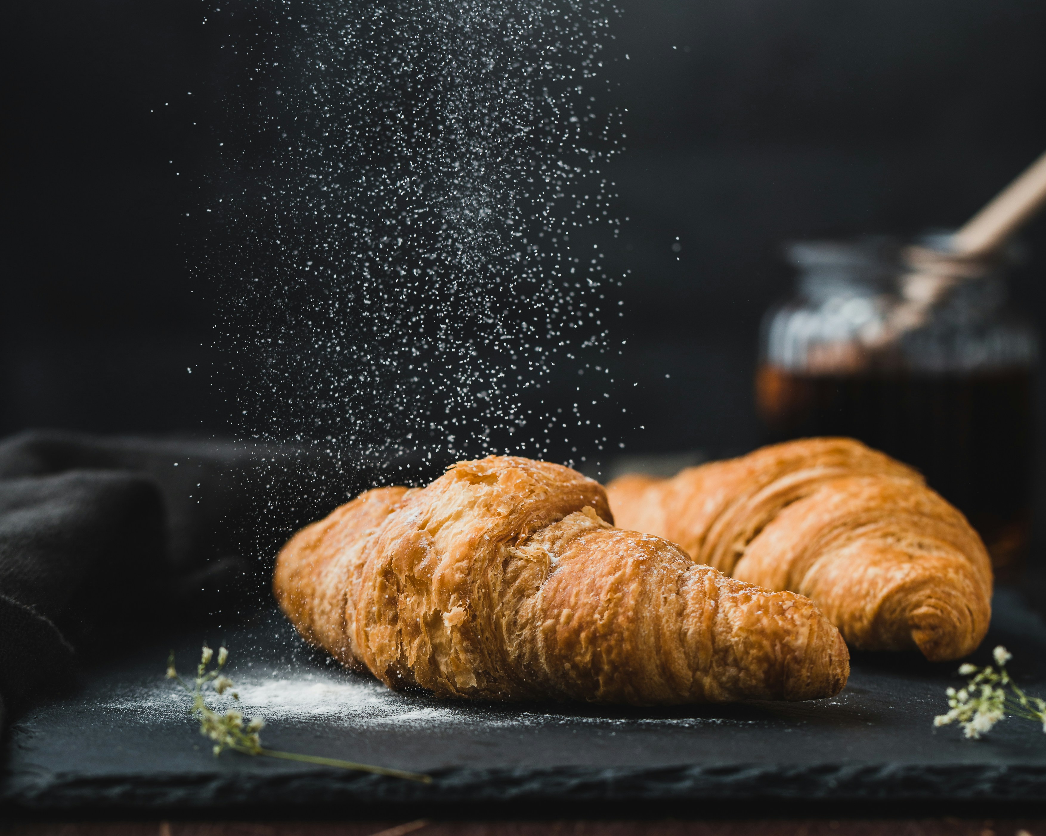 Croissants being sprinkled with sugar